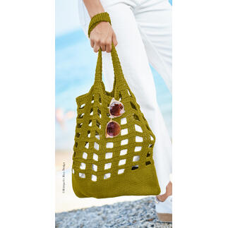 Olivenfarbene Tasche aus Bio-Baumwolle mit Sonnenbrille in der Hand.