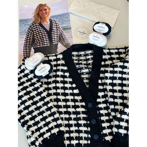 Nahaufnahme der gestreiften Jacke mit Garn und Bild auf dem Tisch.
