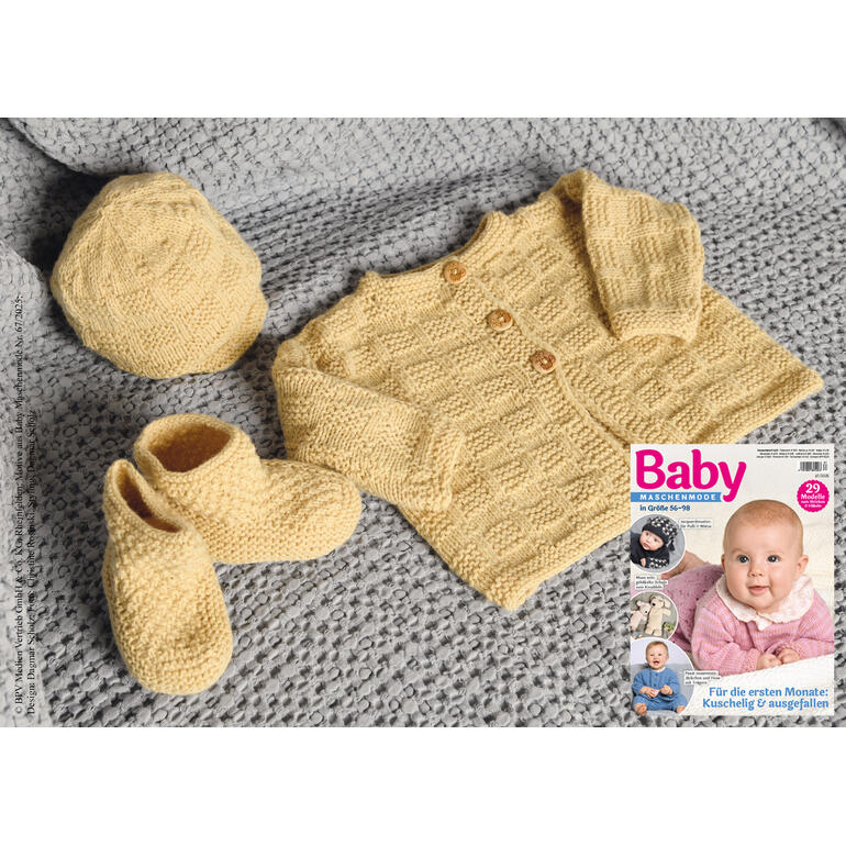 Gelbe Babyjacke, Mütze und Söckchen auf einem grauen Strickstück