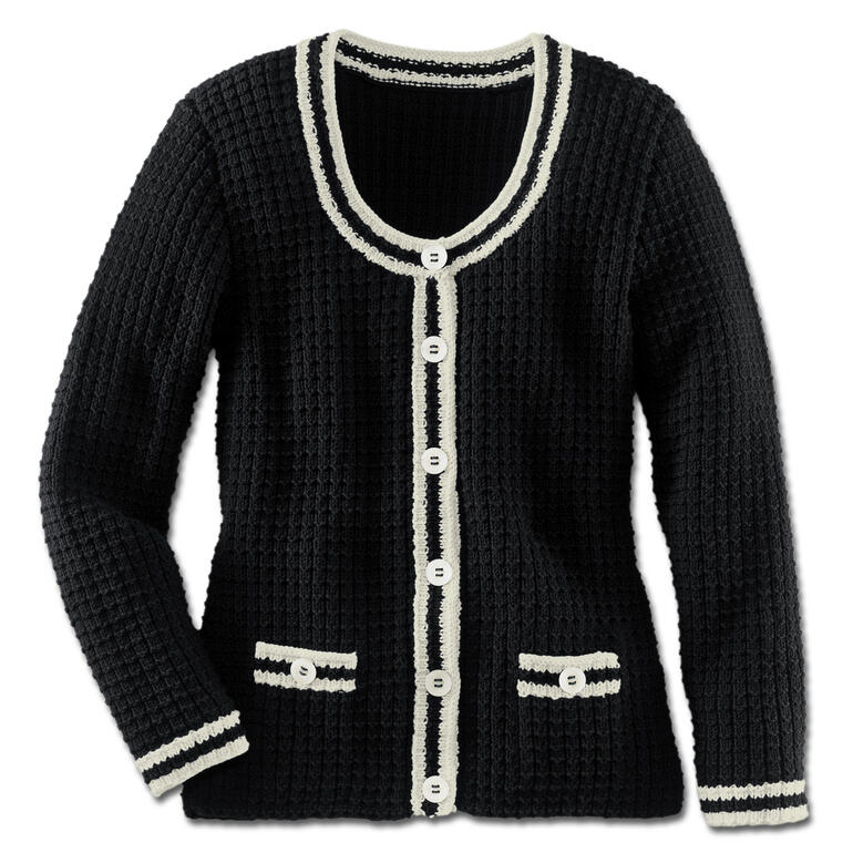 Damenjacke in Schwarz mit weißen Details und Knöpfen, lässig drapiert auf einem Teppich.