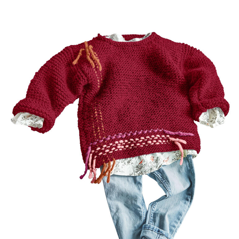 Roter Kinderpulli aus Canoso mit bunten Fransen und lässigem Schnitt.