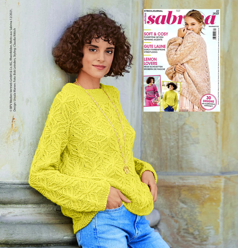 Leuchtend gelber Pullover mit großem, strukturiertem Muster.