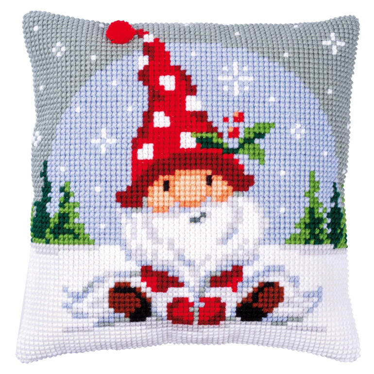 Kissen mit einem Wichtel, der im Schnee sitzt und Geschenke hält.