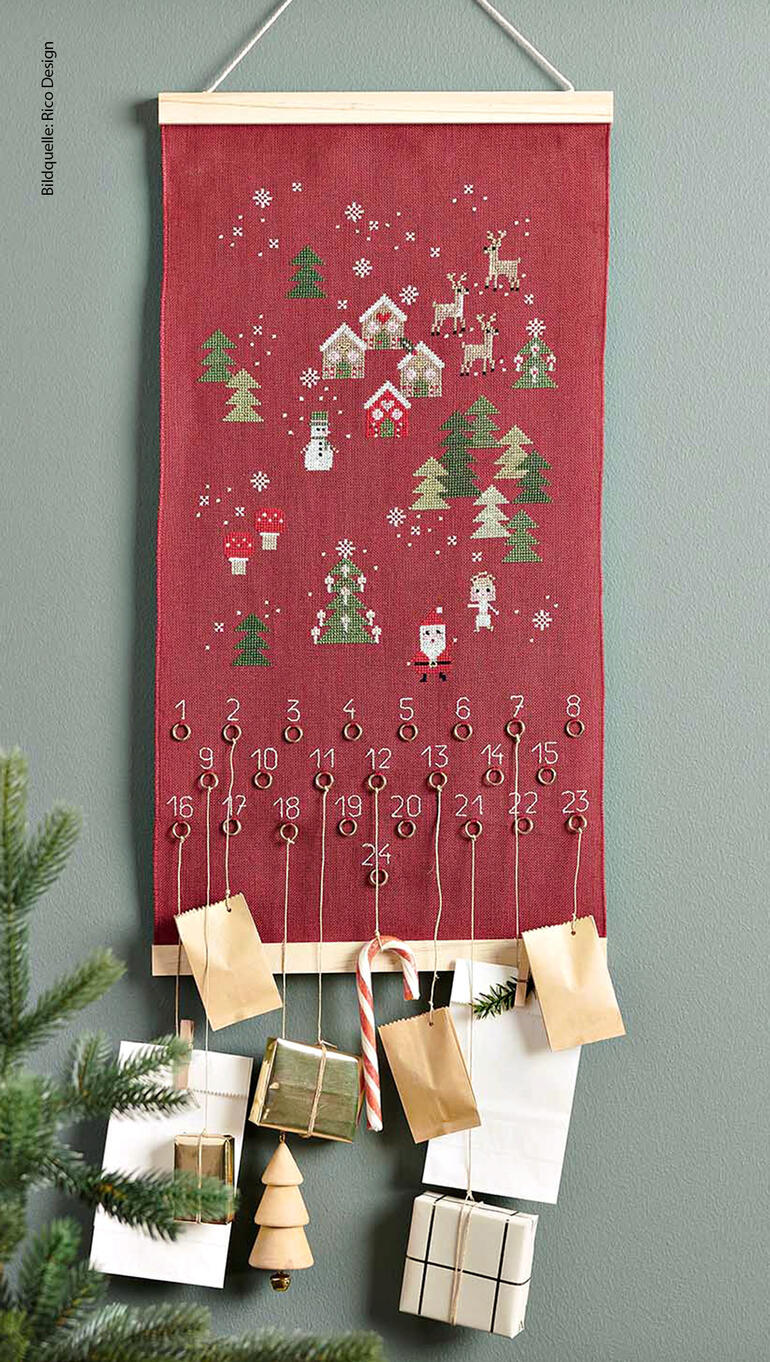 Adventskalender mit Weihnachtslandschaft und Zahlen zum Öffnen.